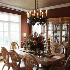 Beautiful wall color and shimmering accented ceiling complete this dining rooms design